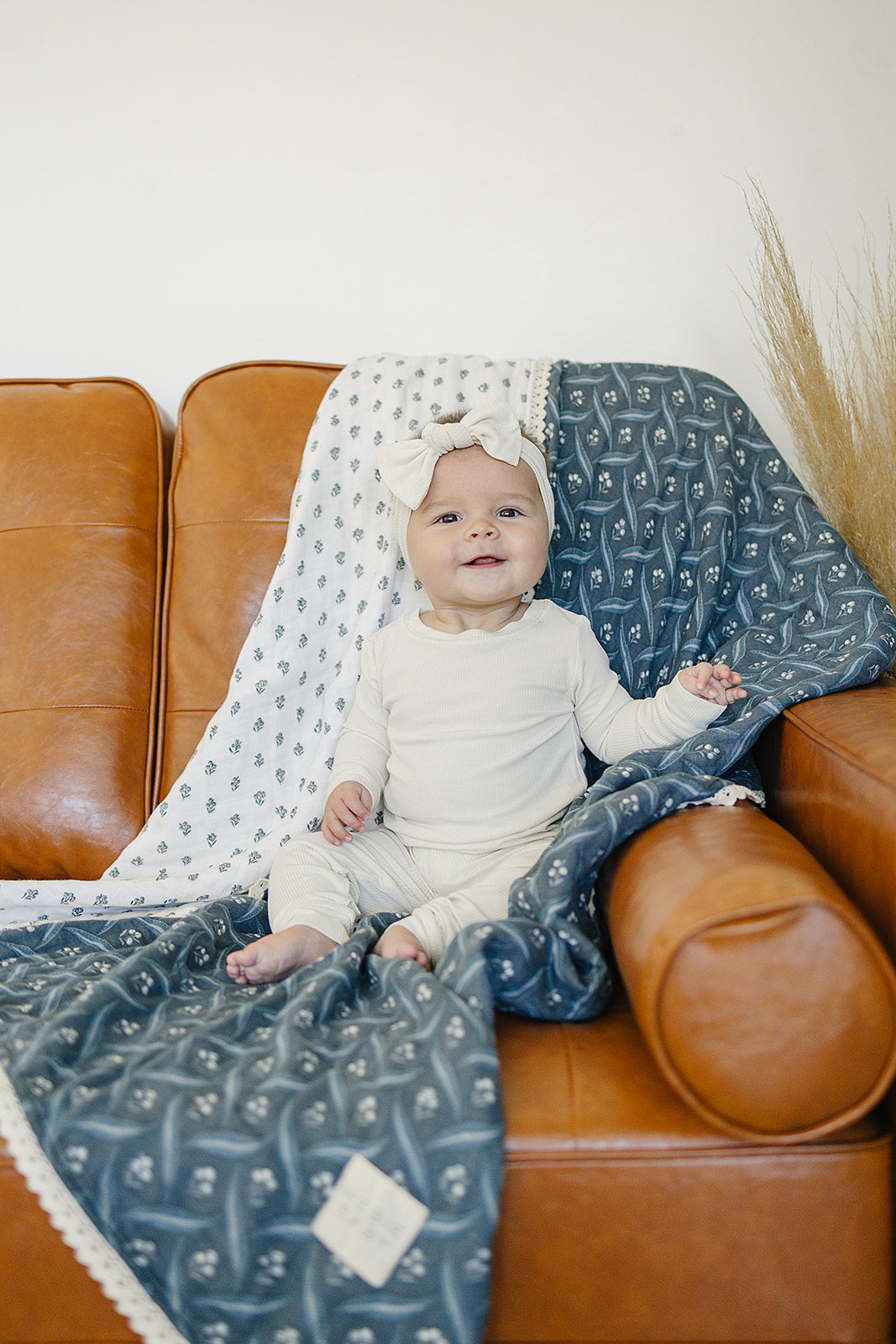 Mebie Baby Navy Berry + Cream Berry Lace Muslin Quilt provides gentle comfort as a breathable muslin.