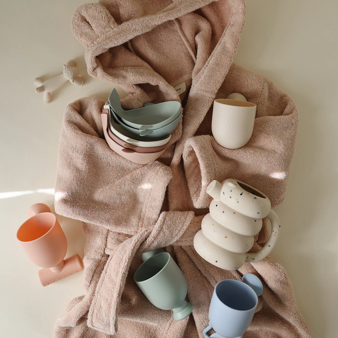Child using Mushie Original Whale Bath Stackers - toddler stacking BPA-free silicone cups in the bath