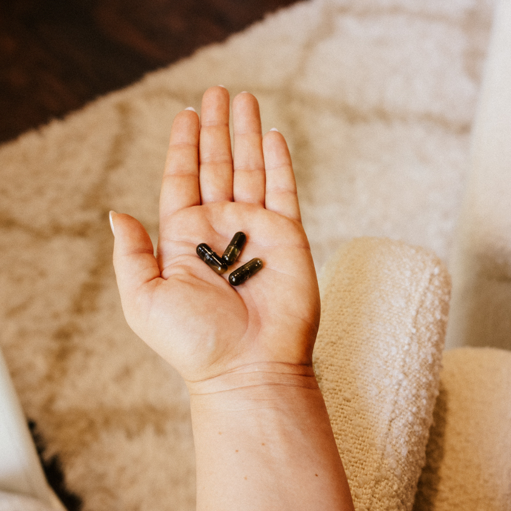 Flat lay of Motherlove Morning Sickness Blend capsules, featuring herbal nutrients among the best postpartum supplements for recovery.