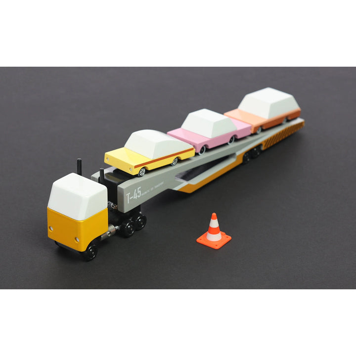 Handcrafted wooden car transporter by Candylab featuring magnetic functionality for interactive play