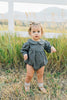 Baby wearing the Mebie Baby Gingham Peter Pan Collar Long Sleeve Bubble Romper