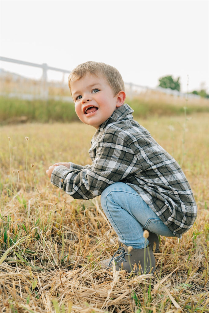 Toddler playing in the charcoal flannel shacket by Mebie Baby