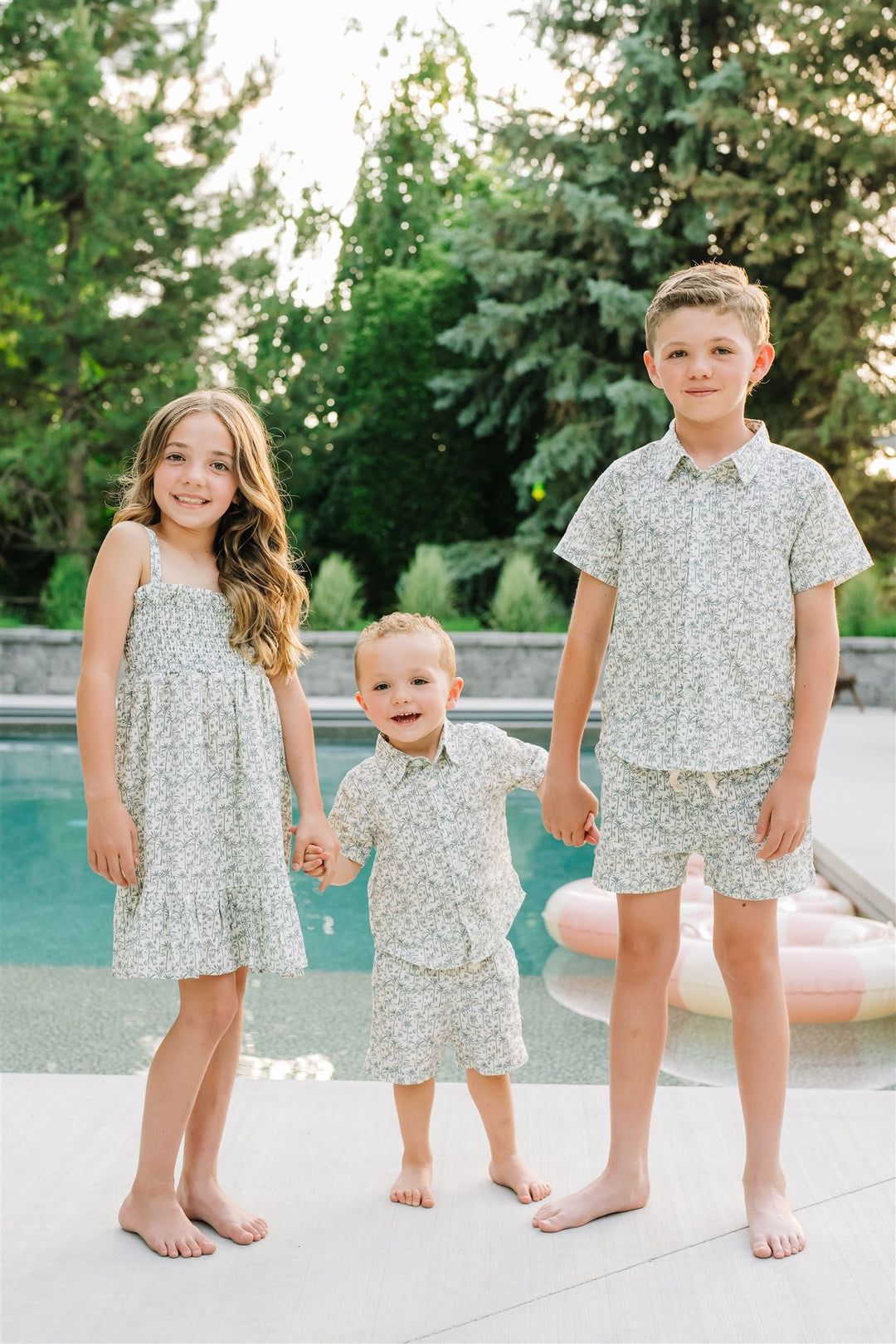 Lifestyle photo of the Palm Tree Linen Dress styled as a linen baby dress for little ones