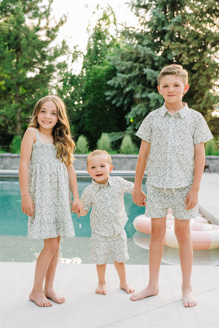 Lifestyle photo of the Palm Tree Linen Dress styled as a linen baby dress for little ones