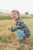 Toddler playing in the charcoal flannel shacket by Mebie Baby Button down sherpa flannel jacket for babies and toddlers