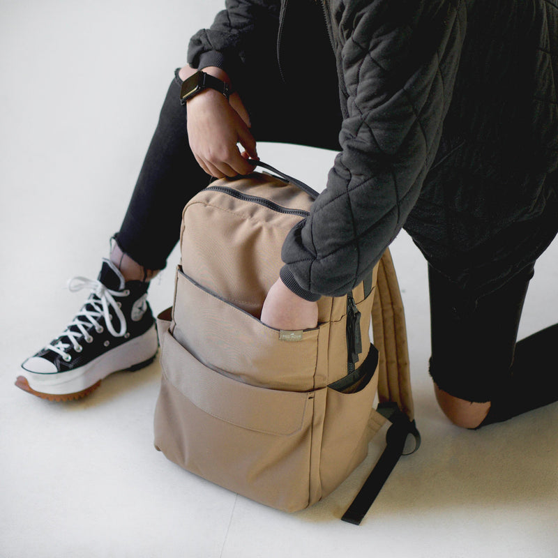 Little Unicorn Red Rovr Roo Backpack - Toffee featured in a lifestyle scene, showcasing timeless style among backpacks kids love.