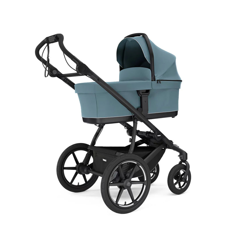 Soft beige Thule Urban Glide stroller with bassinet, ideal for newborns.