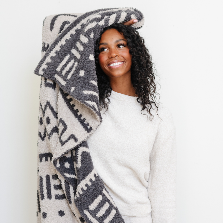 The Saranoni Double-Layer BAMONI¨ Throw Blanket in Mudcloth Print blends stylish design with plush fabric, a must-have best blanket for toddler use.