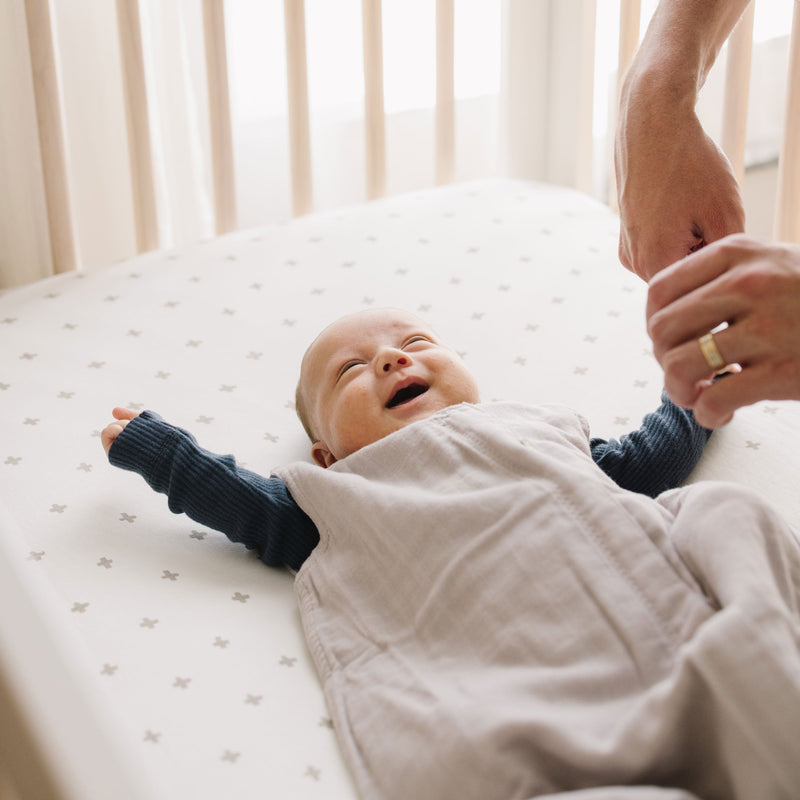 Layered display showing Little Unicorn Cotton Muslin Sleep Bag - Porpoise, baby sleep bags for gentle warmth.