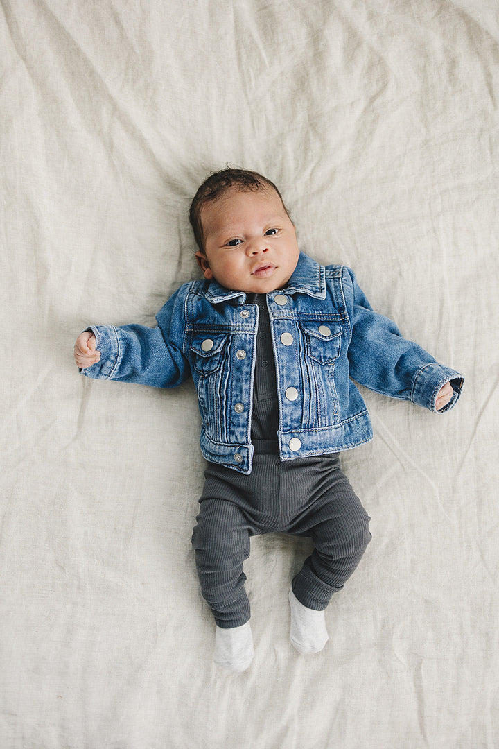 Charcoal Organic Snap Long Sleeve Ribbed Bodysuit from Mebie Baby, shown up close to highlight the snap closures.