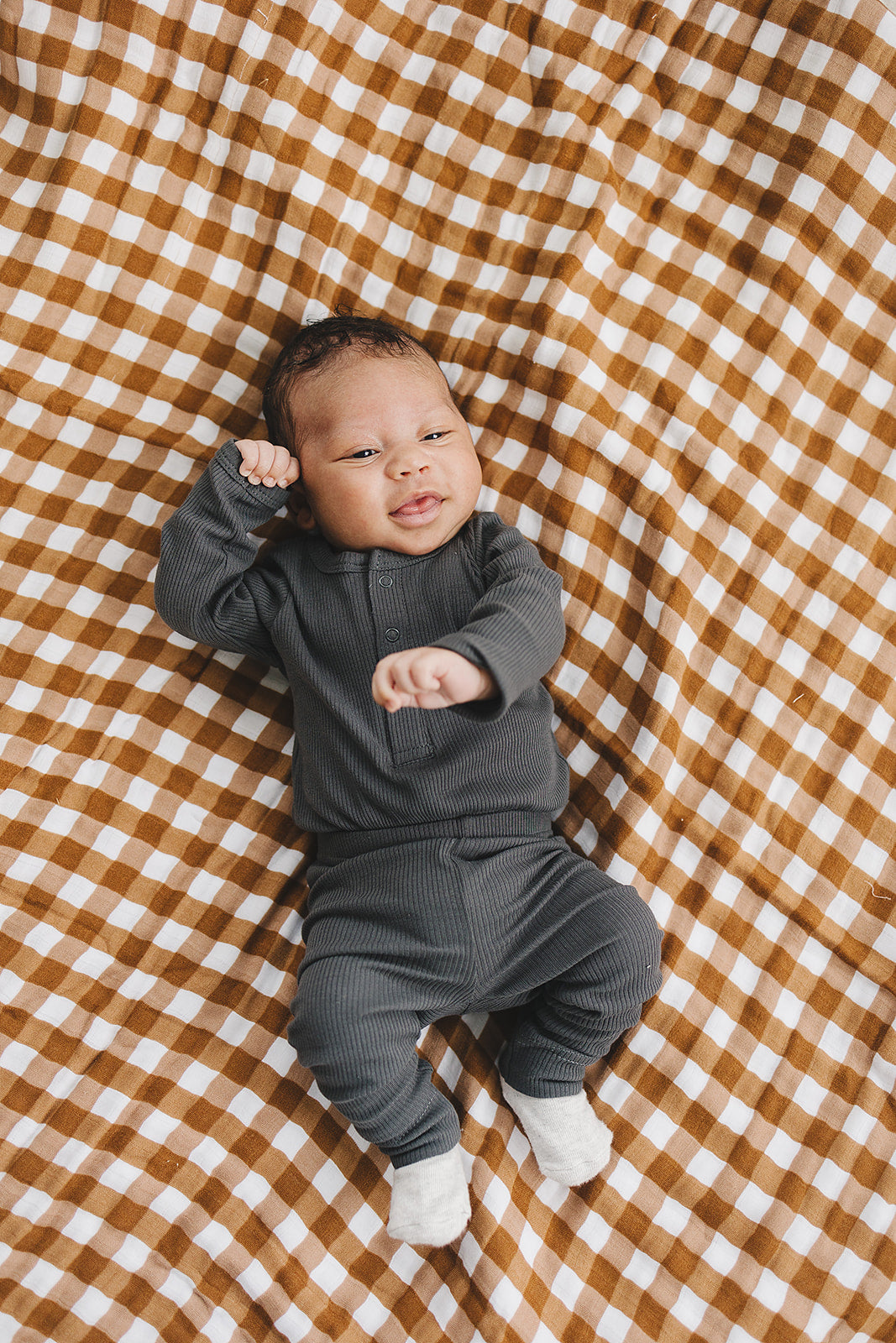 Styled with matching baby leggings, the Mebie Baby Charcoal Organic Snap Long Sleeve Ribbed Bodysuit.