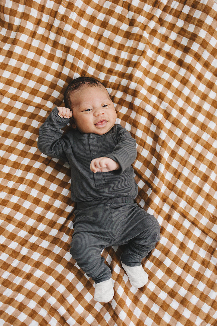 Styled with matching baby leggings, the Mebie Baby Charcoal Organic Snap Long Sleeve Ribbed Bodysuit.