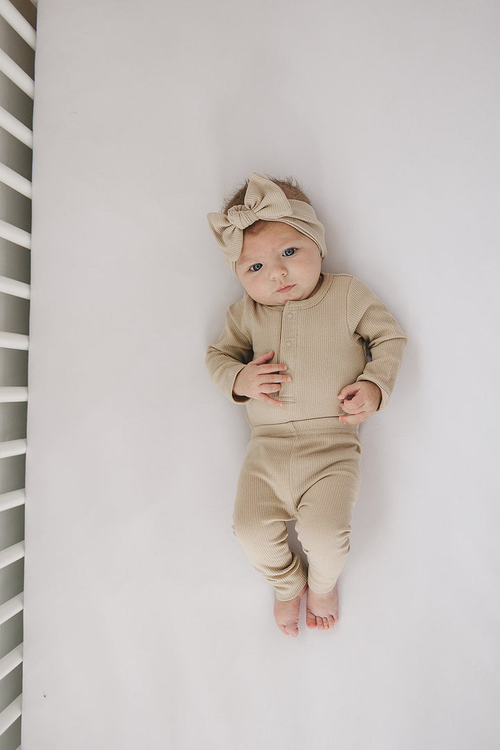 Organic cotton ribbed baby bodysuit, the Oatmeal Organic Snap Long Sleeve Ribbed Bodysuit styled with matching baby leggings.