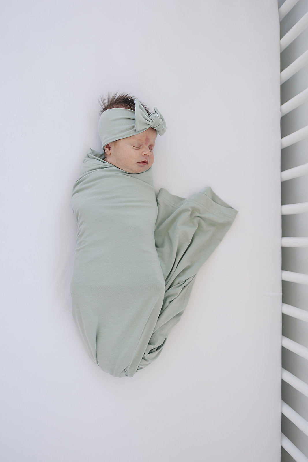 Breathable bamboo swaddle blanket for newborns, the Sage Bamboo Stretch Swaddle shown in a flat lay to highlight the fabric.