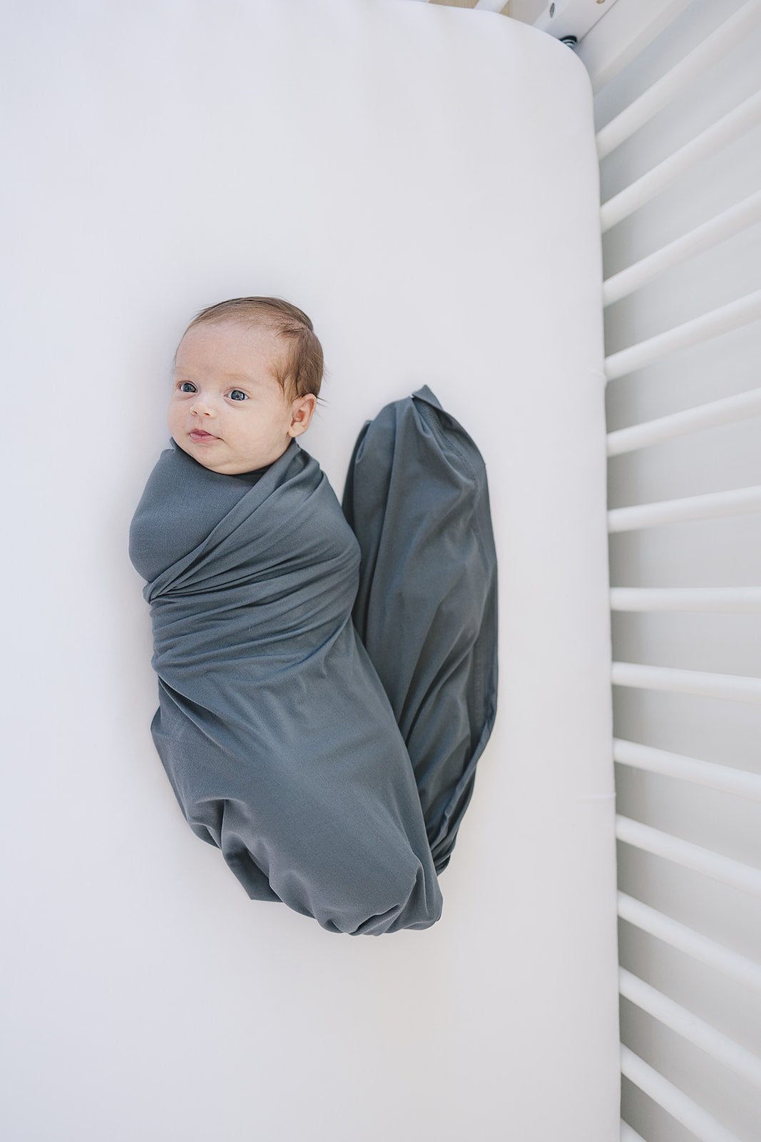 Snuggle your baby in the Mebie Baby Charcoal Bamboo Stretch Swaddle, a comfortable infant swaddle blanket.