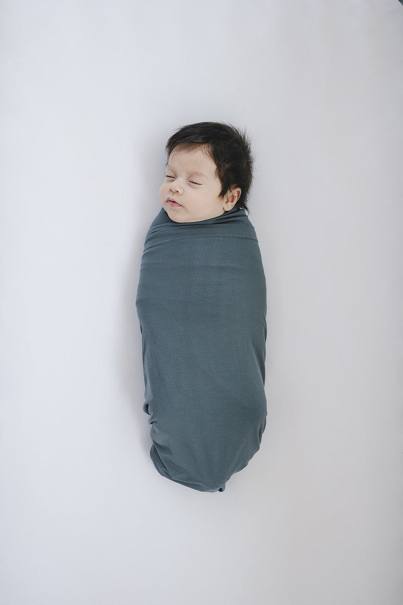 Cuddle your infant in the Mebie Baby Charcoal Bamboo Stretch Swaddle, a gentle baby swaddle wrap.