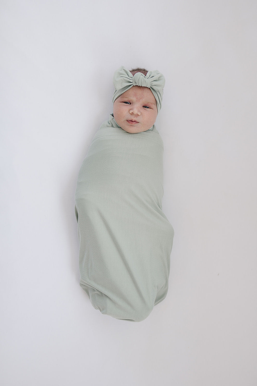 Sage Bamboo Stretch Swaddle from Mebie Baby, shown in a flat lay to highlight the fabric.