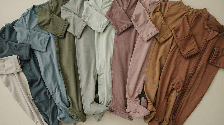 Close up detail shot of the Mebie Baby Rust Bamboo Footed Zipper fabric and stitching