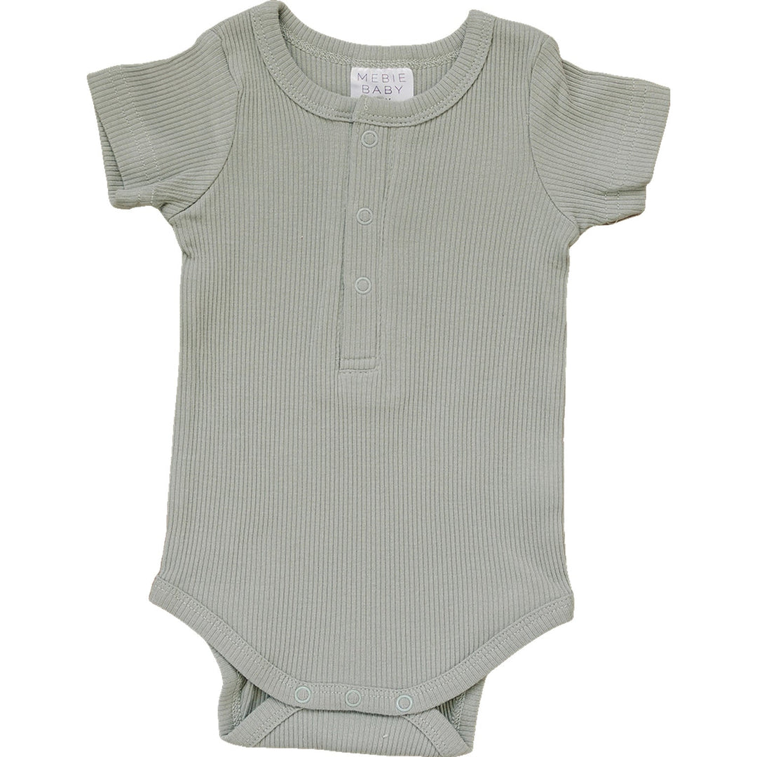 Sage Organic Cotton Ribbed Snap Bodysuit by Mebie Baby, worn by a crawling baby.