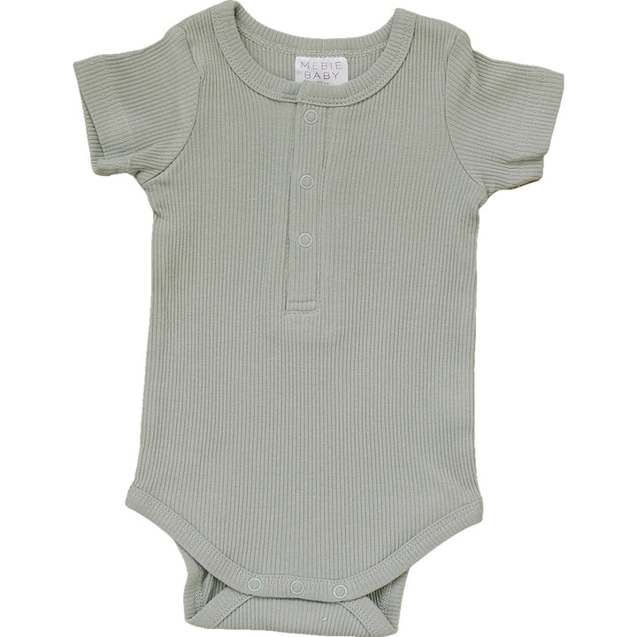 Sage Organic Cotton Ribbed Snap Bodysuit by Mebie Baby, worn by a crawling baby.