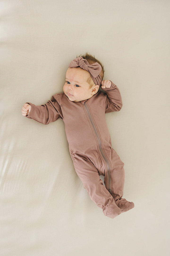 Mebie Baby Plum Bamboo Footed Zipper photographed in natural light to show true color
