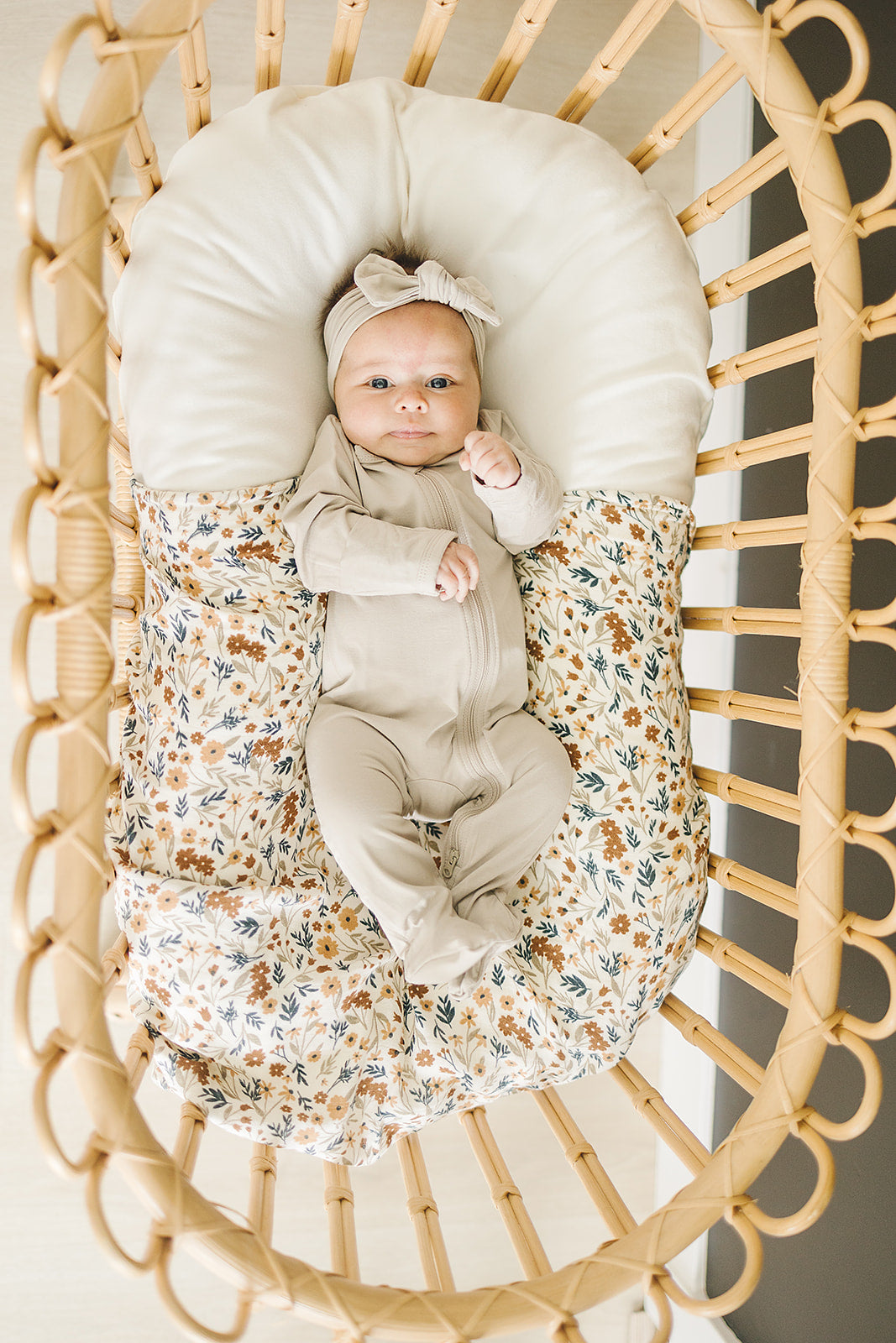 Organic cotton footie pajama for babies, the Oatmeal Bamboo Footed Zipper zipped up on a smiling infant.