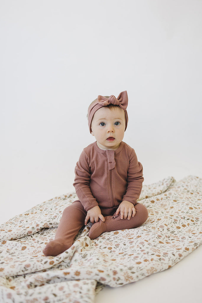 Baby wearing the organic cotton footed one piece pajamas