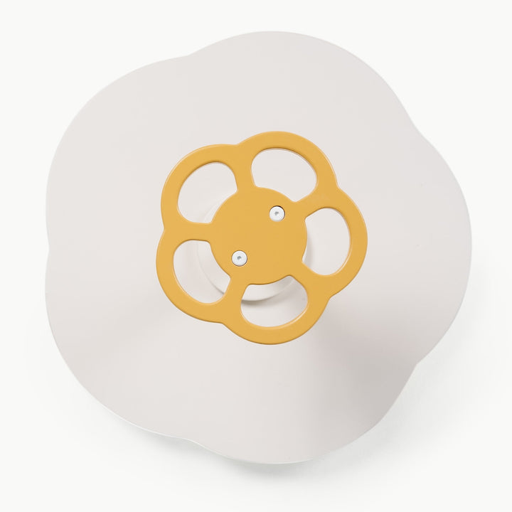 Overhead view of the mustard gold wheel handle on Gathre's wooden Sit and Spin