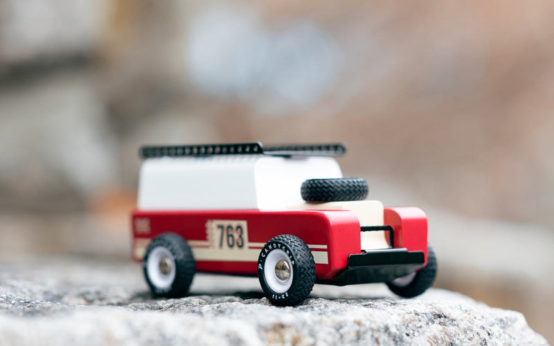 The Plantoys Drifter Nigel photographed on stone shows rugged character, appealing to families wanting race car toys.