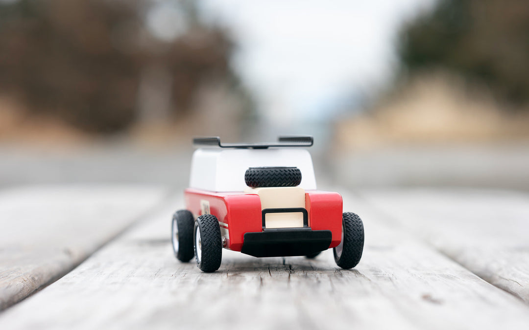 The Plantoys Drifter Nigel set on a tabletop offers a clean, modern aesthetic, perfect for big toy car enthusiasts.