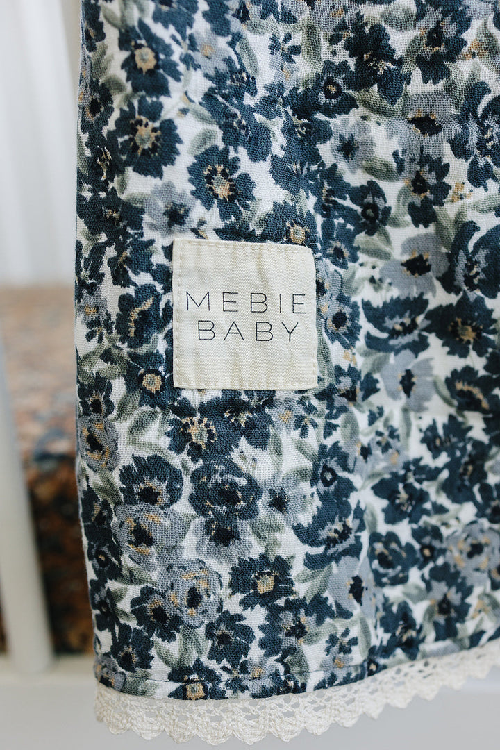 Texture-focused view of Mebie BabyÕs Liberty Floral + Coastal Plaid Lace Muslin Quilt, an elegant muslin quilt for infants.