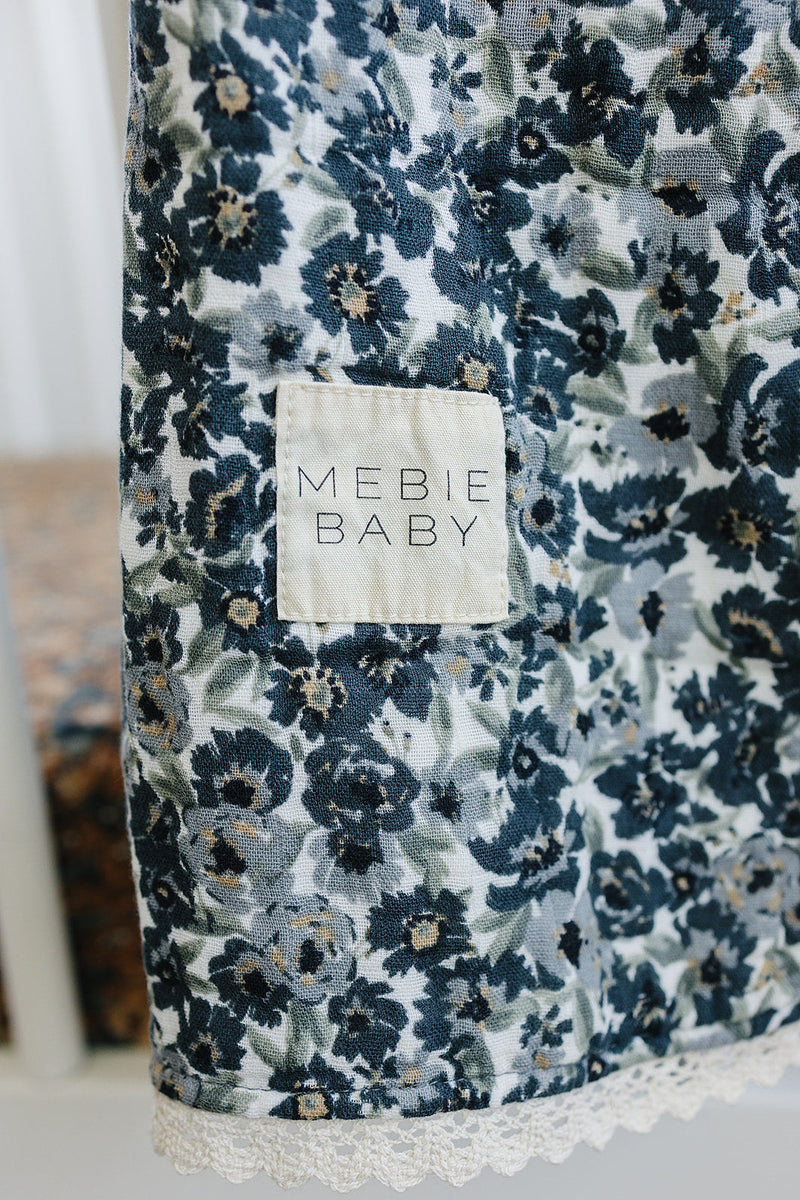 Texture-focused view of Mebie BabyÕs Liberty Floral + Coastal Plaid Lace Muslin Quilt, an elegant muslin quilt for infants.