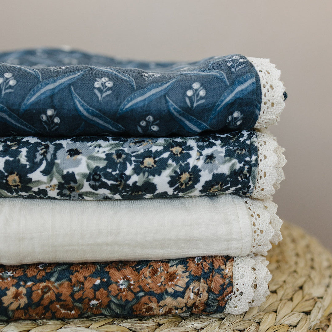 Perfect for stroller walks or naps, the Mebie Baby Venetian Floral + Autumn Bloom Lace Muslin Quilt is a muslin throw blanket must-have.