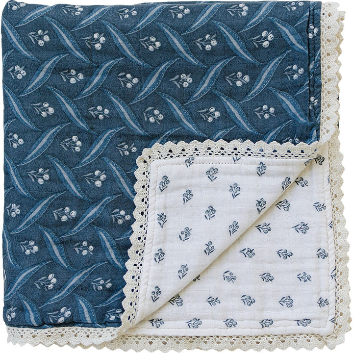 Snuggle your baby in the Mebie Baby Navy Berry + Cream Berry Lace Muslin Quilt, a soft baby blanket.