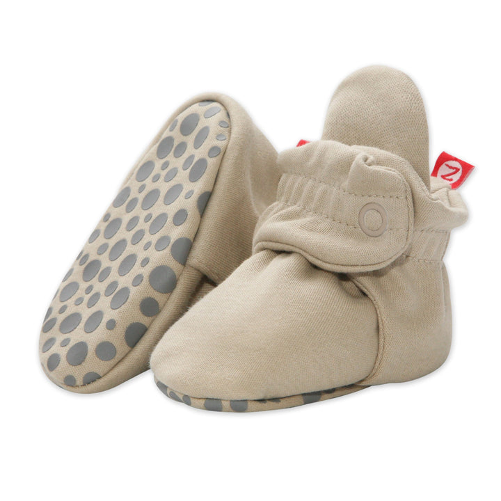 Khaki pair of Zutano organic cotton baby booties with two snap closures and rubber gripper soles, open box 6M