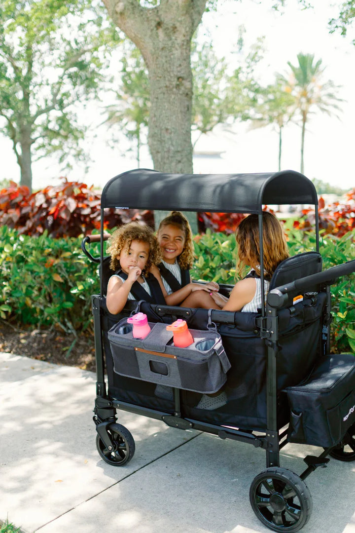 Lifestyle image of black Wonderfold Parent Console highlighting stroller accessories for organized travel
