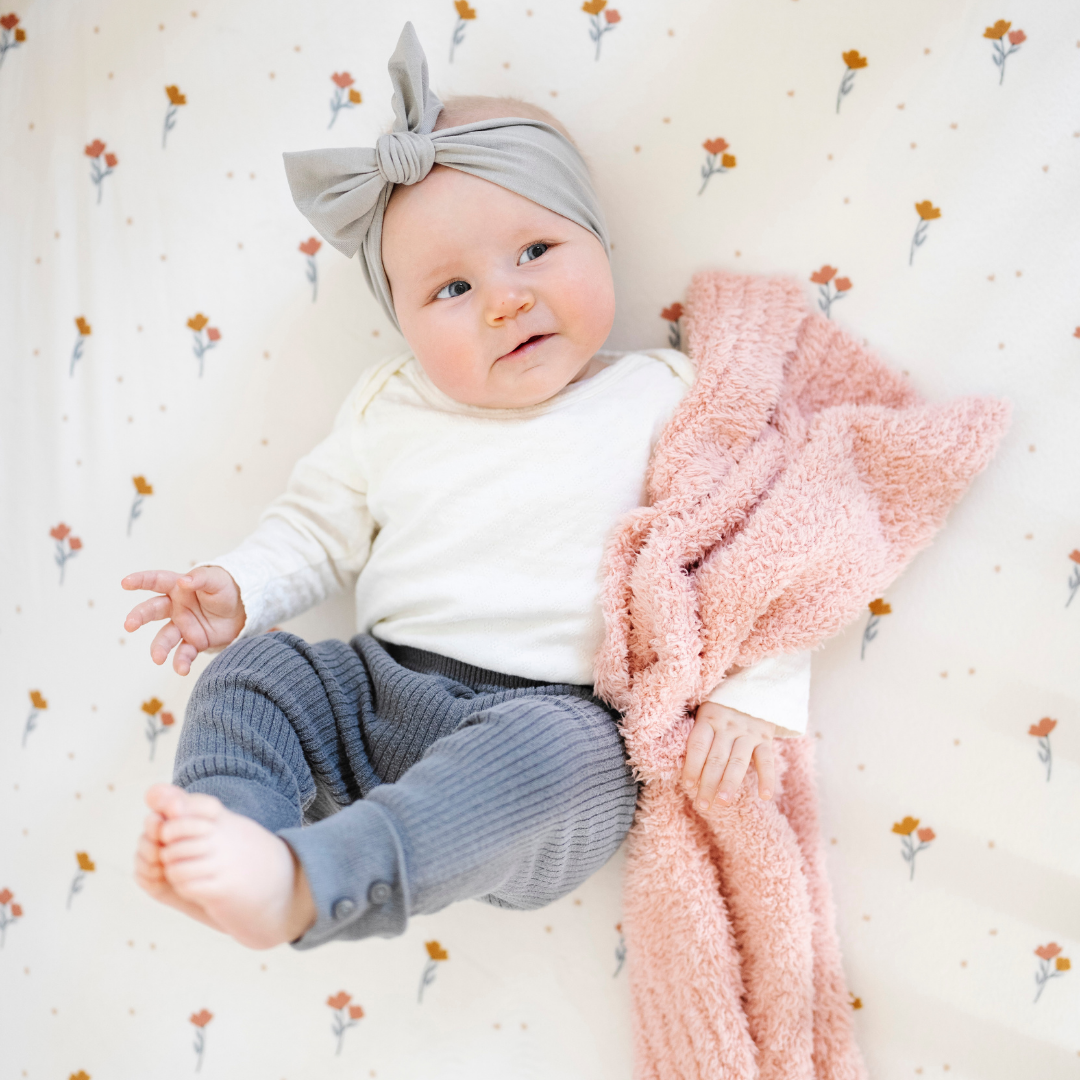 The Saranoni BAMBONI¨ Mini Blanket in Peach offers lightweight coziness, one of the best baby blankets for snuggles.