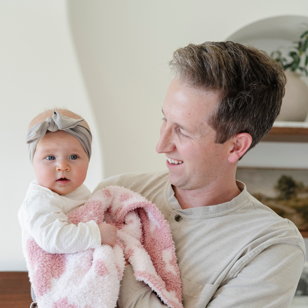 The Saranoni Double-Layer BAMBONI¨ Mini Blanket in Petal wraps your baby girl in plush comfort, a soft baby blanket made for tender snuggles.