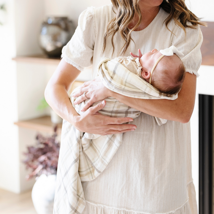 Wrap your infant in comfort with the Saranoni Minky Stretch Receiving Blanket in Classic Plaid, one of the best baby blanket picks.
