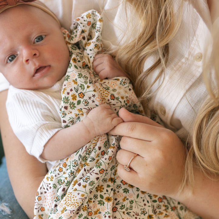 Snuggle your newborn with Little Unicorn Pressed Petals Stretch Knit Swaddle Blanket, soft muslin swaddle.