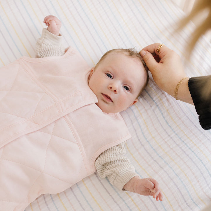 Close-up of Little Unicorn Cotton Muslin Quilted Sleep Bag - Light Pink, sleeping bag baby with quilted texture.