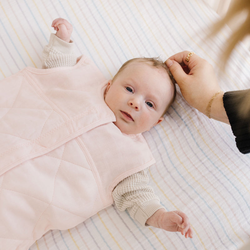Close-up of Little Unicorn Cotton Muslin Quilted Sleep Bag - Light Pink, sleeping bag baby with quilted texture.