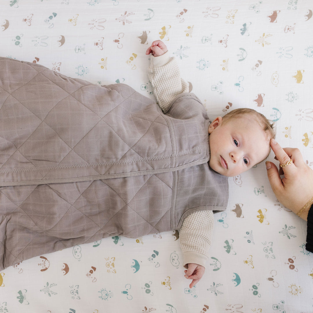 Keep your baby snug with Little Unicorn Cotton Muslin Quilted Sleep Bag - Mocha, a soft sleep bag baby.