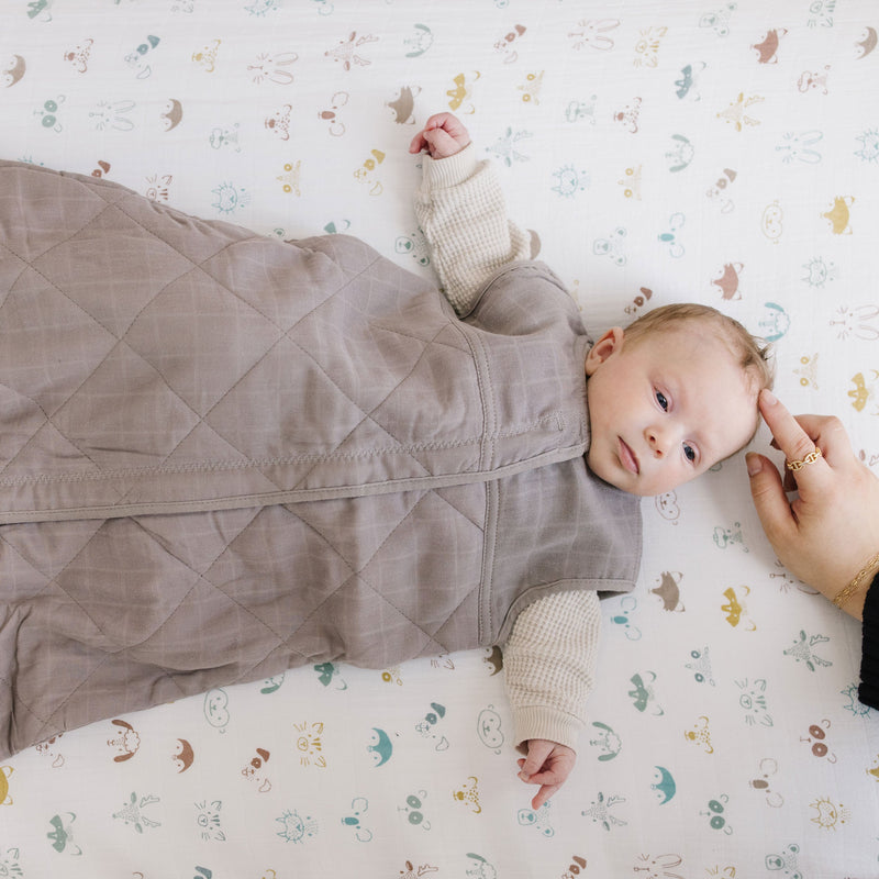 Keep your baby snug with Little Unicorn Cotton Muslin Quilted Sleep Bag - Mocha, a soft sleep bag baby.