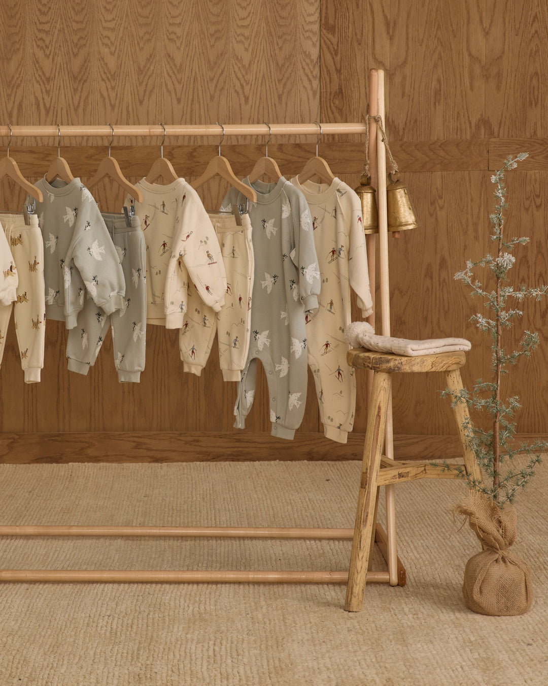 rylee and cru raglan baby jumpers and clothes on rack in room