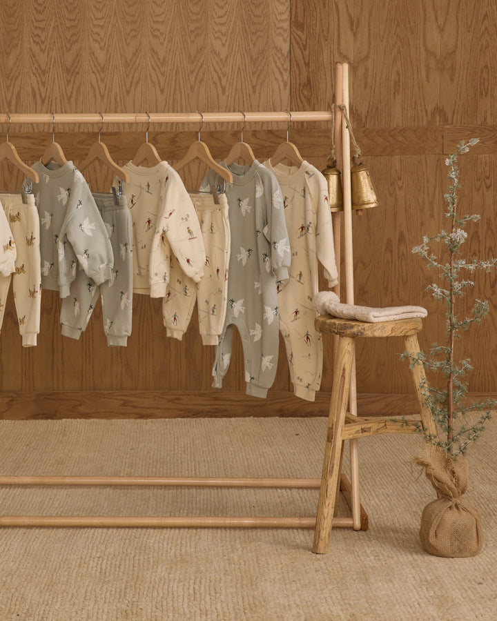 rylee and cru raglan baby jumpers and clothes on rack in room