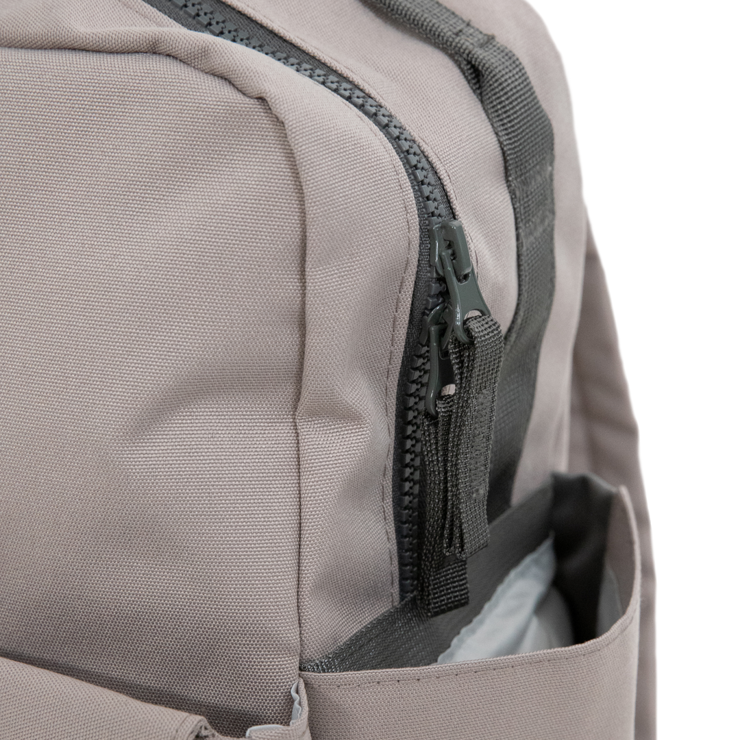 Little Unicorn’s Red Rovr Mini Roo Backpack - Truffle stands out as one of the best kids backpacks for style and durability.