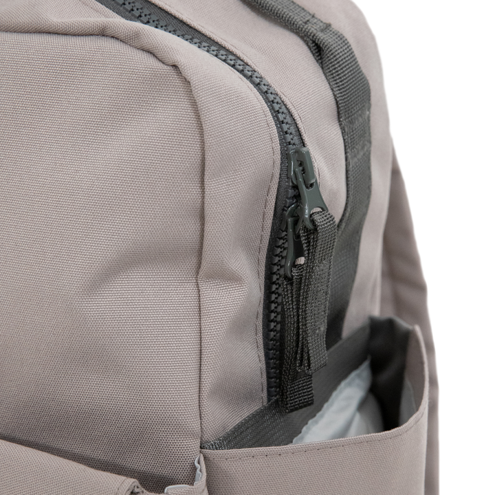 Little Unicorn’s Red Rovr Mini Roo Backpack - Truffle stands out as one of the best kids backpacks for style and durability.