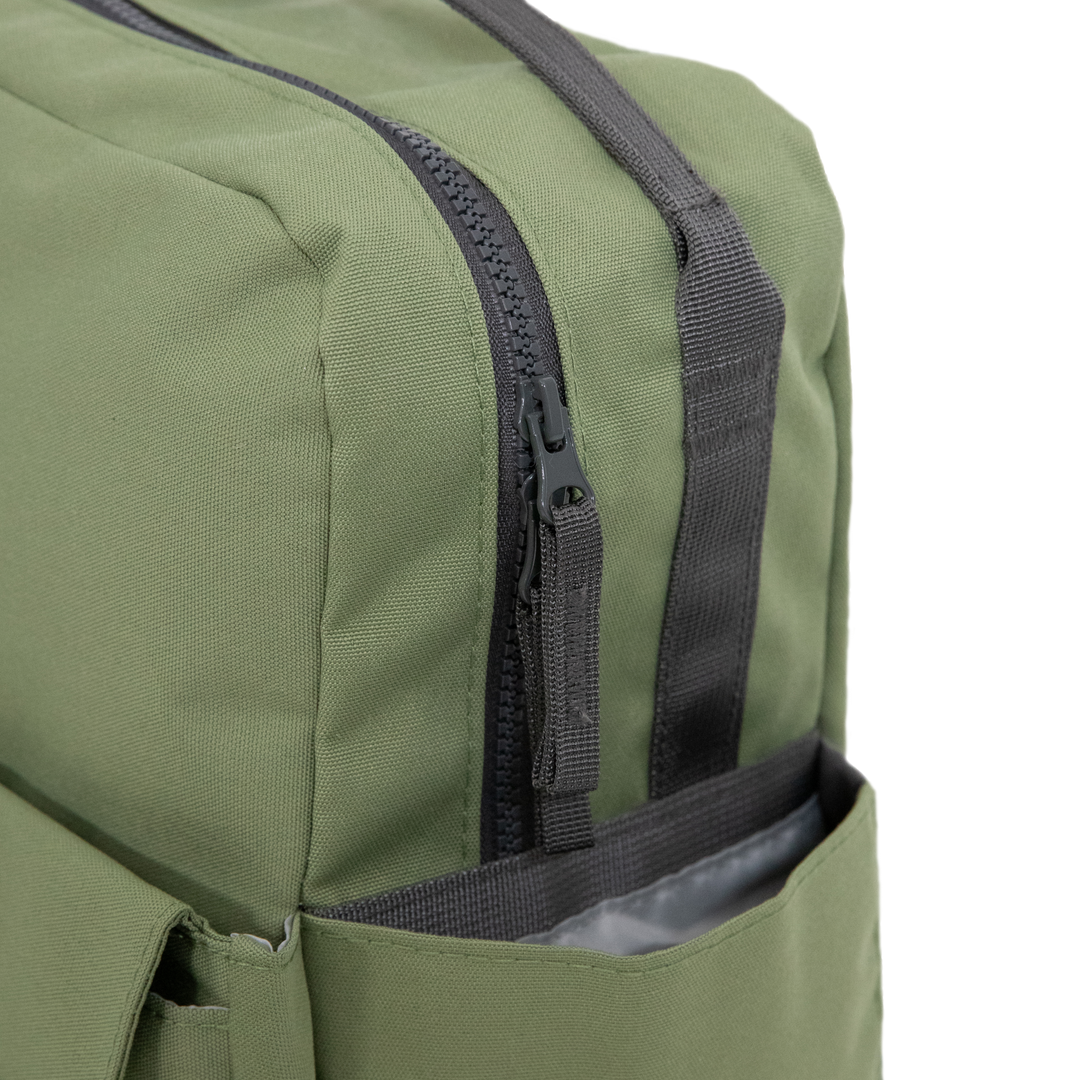 Side angle of the Little Unicorn Red Rovr Mini Roo Backpack in Moss, ideal for families seeking the best kids backpacks.