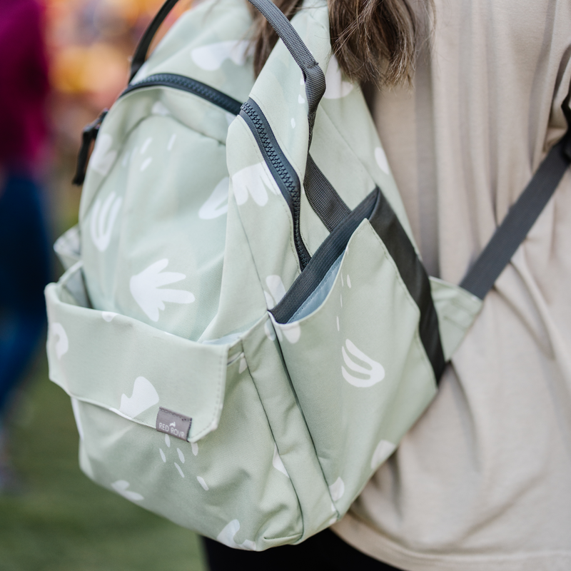 Shown unzipped, the Little Unicorn Red Rovr Mini Roo Backpack - Pear Doodle makes organizing easy for kids school backpacks.